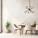 Varlin 12 Pendant Light installed above a dining table, showcasing a designer starburst chandelier with warm decorative illumination.