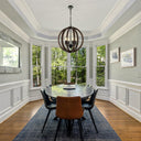 Modern farmhouse pendant light featuring a round wooden cage frame, four candle-style lights, and elegant French Provincial design.