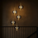 Modern 5-light LED pendant featuring smoke glass shades, matt black finish, and designer ceiling lighting for contemporary interiors.