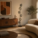 Mid-century inspired floor lamp enhancing a boutique hotel suite with textured glass globes and refined contemporary styling.
