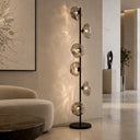 Designer living room floor lamp featuring six illuminated glass spheres that create warm ambient lighting with artistic visual appeal.