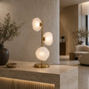 Zecca Modern table lamp with glass shades on a concrete surface in a stylish room.