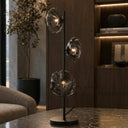 Zecca Black smoke Modern table lamp with three glass shades on a marble surface in a stylish room.