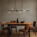 Designer linear chandelier featuring smoke textured glass shades, minimalist metal frame, and luxury lighting for open-plan living spaces.