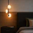 Luxury textured glass pendant light with smoke glass shades, black finish, and statement lighting for contemporary residential interiors.