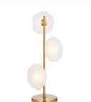 Zecca Table Lamp with handcrafted burlap texture glass creating warm ambient lighting in a modern living room