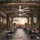 Albatross Martec large ceiling fan  cooling large Outdoor dining area with people sitting at tables under a wooden pergola with floral decorations, sunset in the background.