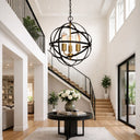 APOLLO Pendant Light P5 60CM BRZ/GLD Modern interior with a large spherical chandelier, staircase, and decorative table.