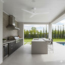 Modern outdoor kitchen with  Martec Avoca Ceiling Fan and Remote control  island, grill, and view of garden and pool.Lights and fans Online