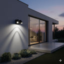 Martec Capri 9W Tricolour LED Spotlight in a Modern house exterior with outdoor lighting fixture and view into a living room from Lights and Fans Online 