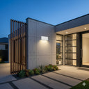 Martec Modus Tricolour LED Up/Down Wall Light 6W/10W Modern house exterior with glass doors and a decorative wall at dusk from lights and fans online 