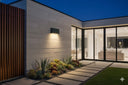 Modus Tricolour LED Up/Down Wall Light 6W/10W in  Modern house exterior with a garden and illuminated interior from lights and fans online 